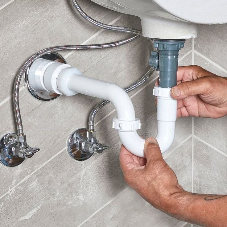 Plumber fitting a modern bathroom tap