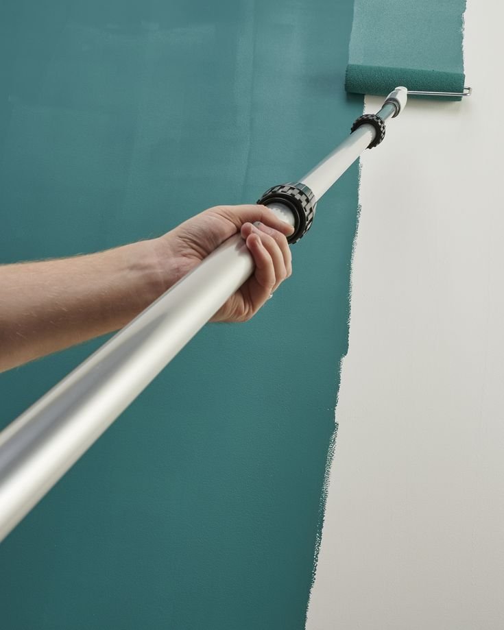 Painter at work on a ceiling in a UK home