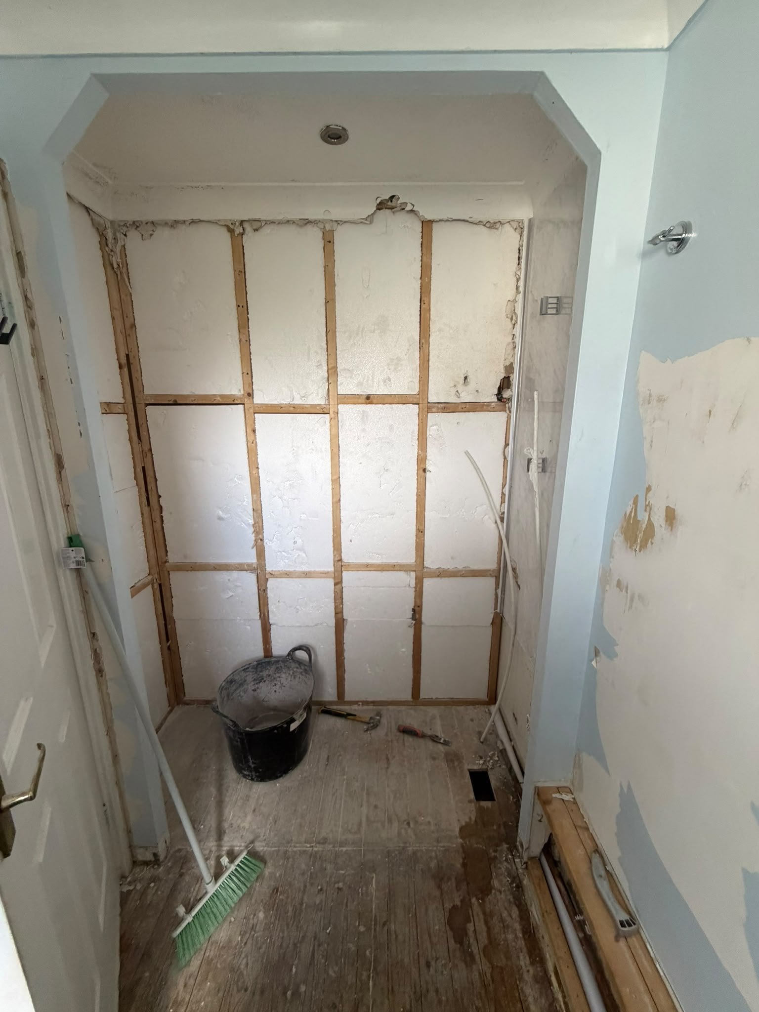 Shower alcove stripped back to the studs before renovation