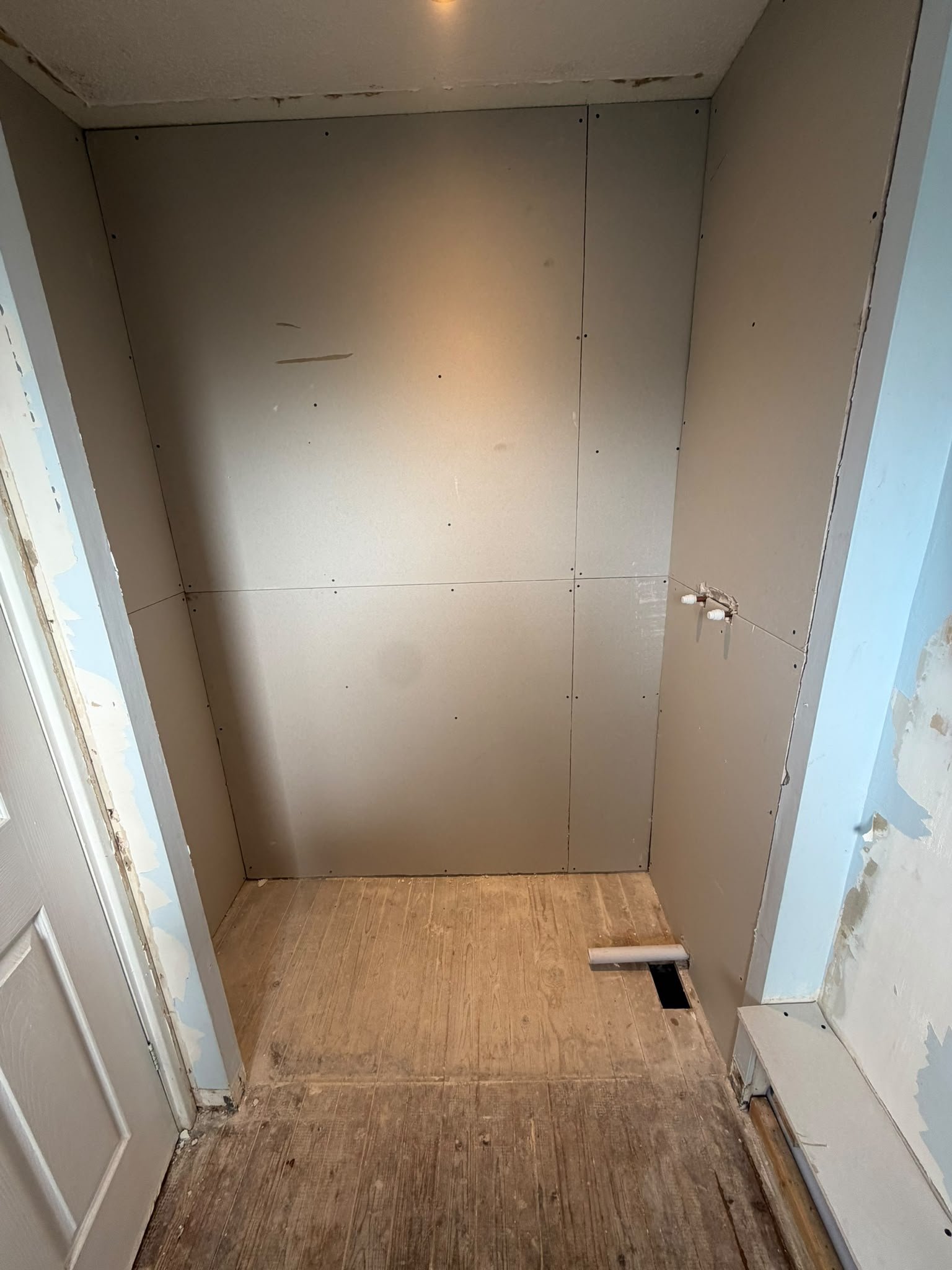 Shower alcove boarded and prepared for tiling