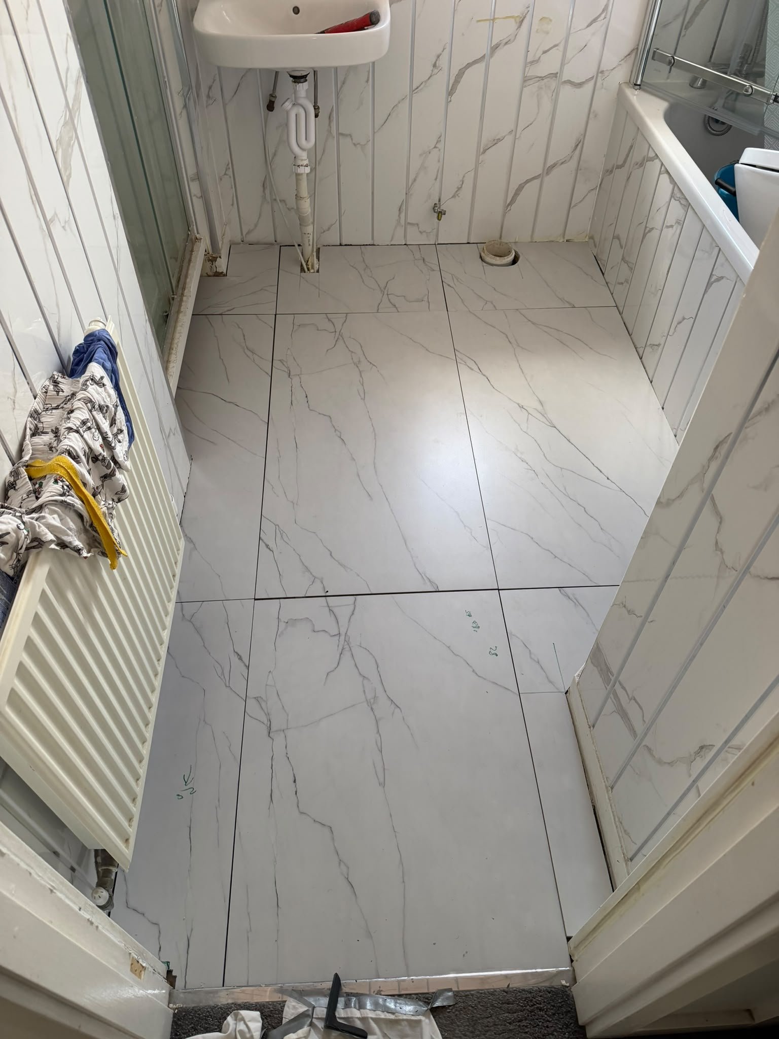 New bathroom floor tiles laid and levelled