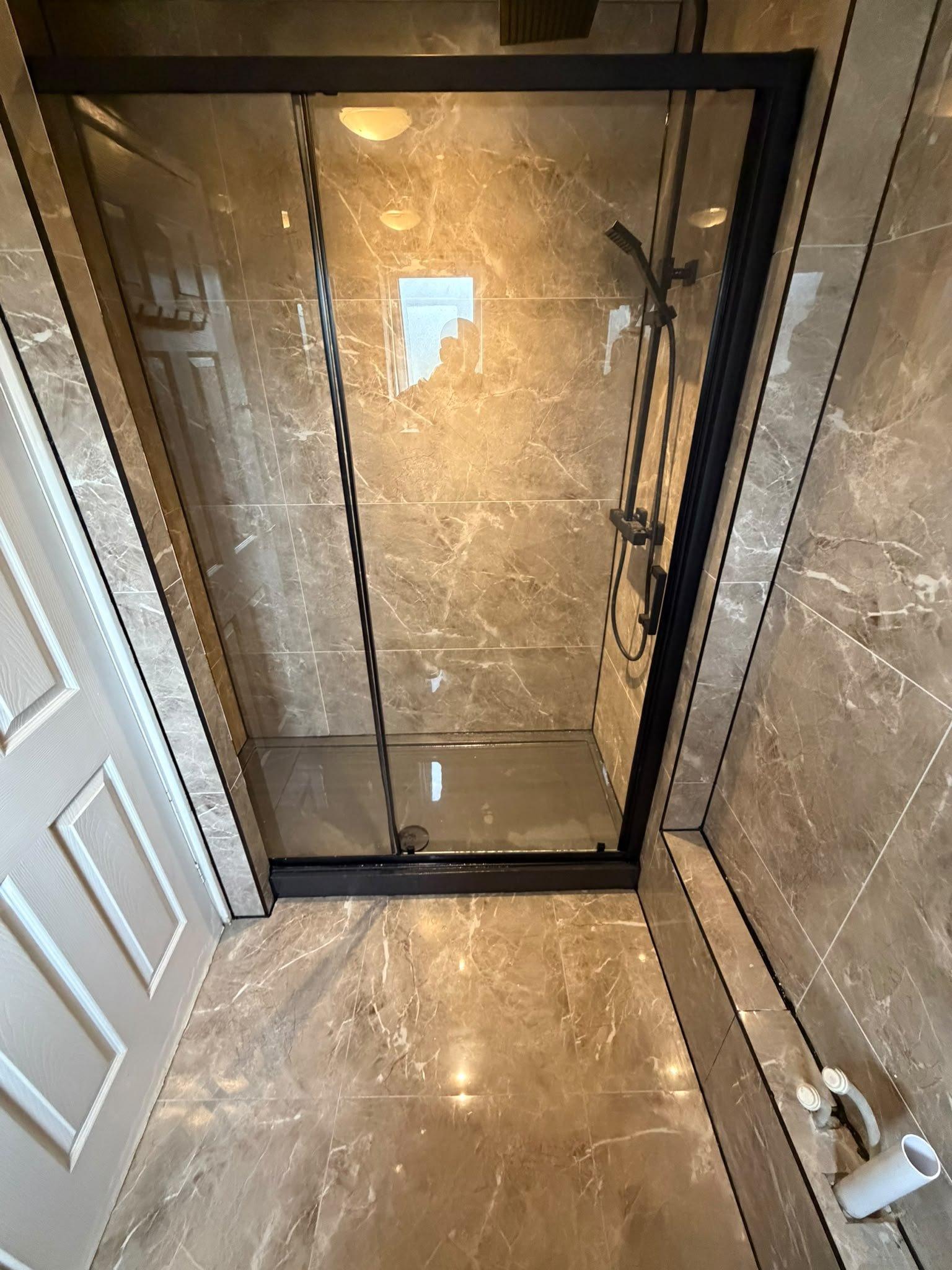 Marble-effect tiled shower enclosure